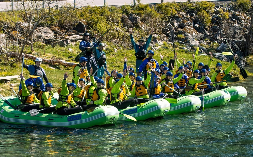 Friends enjoying white water rafting during bachelor party event celebration in raundal river